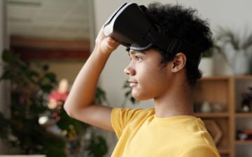 photo of boy holding a vr headset